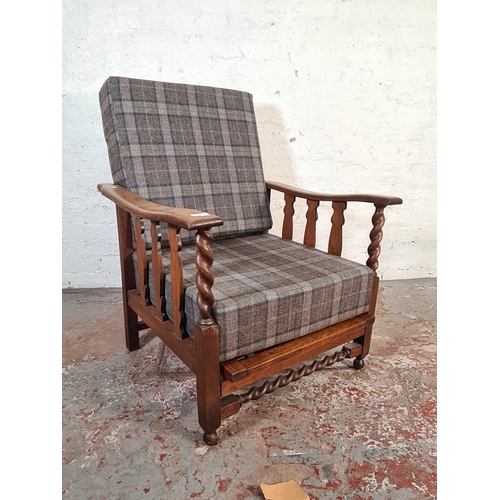 417 - An early/mid 20th century oak framed reclining armchair with tartan upholstery