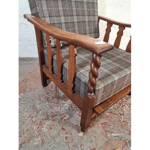 417 - An early/mid 20th century oak framed reclining armchair with tartan upholstery