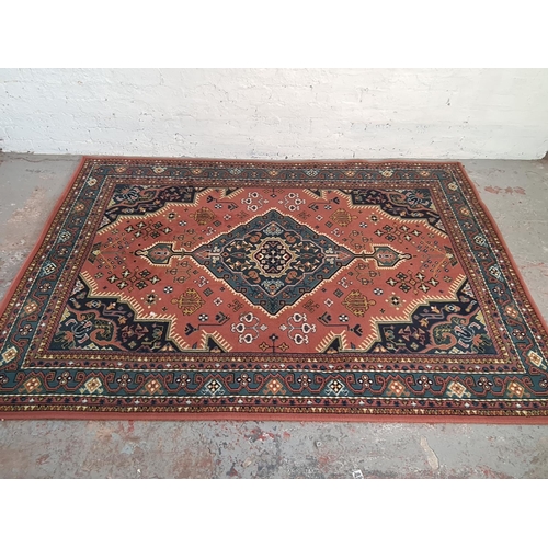 A vintage red and blue rug - approx. 227cm x 160cm