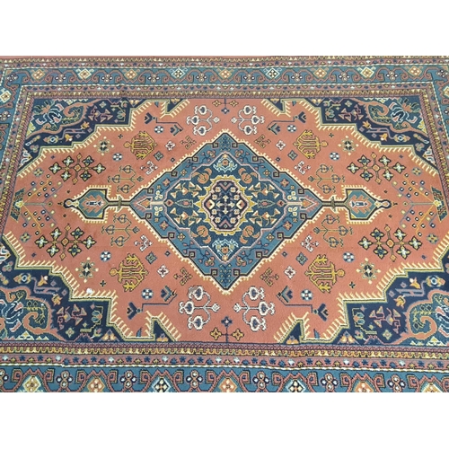 420 - A vintage red and blue rug - approx. 227cm x 160cm