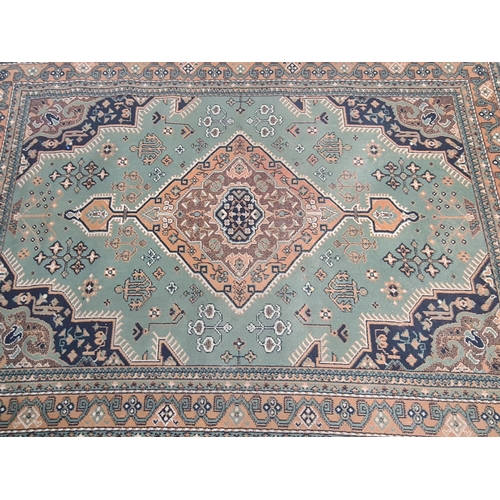 421 - A vintage green and beige rug - approx. 221cm x 159cm