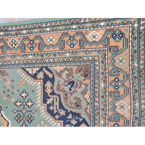 421 - A vintage green and beige rug - approx. 221cm x 159cm