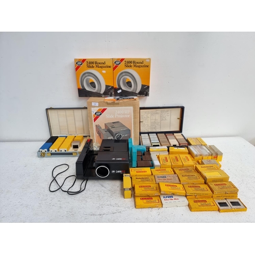 A boxed Boots 2400RF slide projector with a large collection of slides