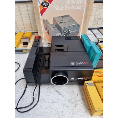 A boxed Boots 2400RF slide projector with a large collection of slides