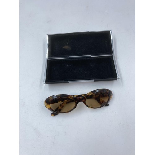 130 - Two pairs of lady's sunglasses, one Gucci tortoiseshell effect framed oval and one cased Emilio Pooc... 