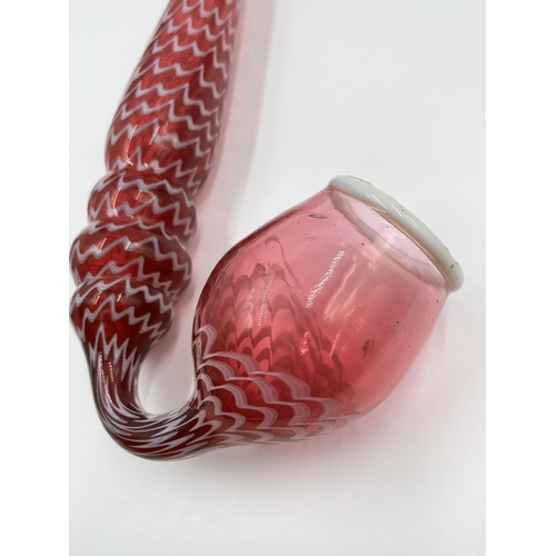 21 - A 19th century Nailsea cranberry and white swirl glass pipe - approx. 38cm long