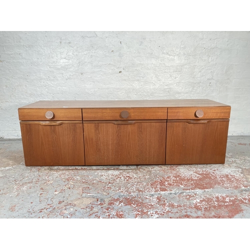 423A - A 1960s teak sideboard with three drawers, two cupboard doors and central drinks cabinet - approx. 5... 