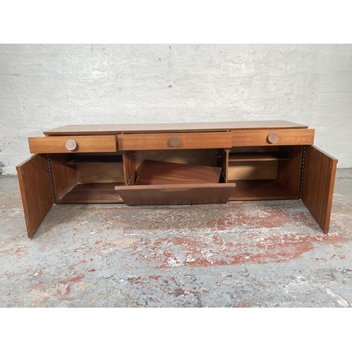 423A - A 1960s teak sideboard with three drawers, two cupboard doors and central drinks cabinet - approx. 5... 