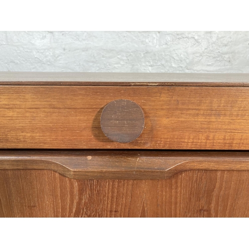 423A - A 1960s teak sideboard with three drawers, two cupboard doors and central drinks cabinet - approx. 5... 