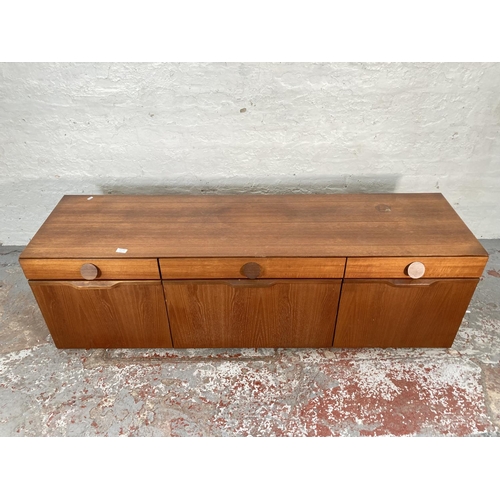 423A - A 1960s teak sideboard with three drawers, two cupboard doors and central drinks cabinet - approx. 5... 