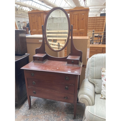 425 - An Edwardian inlaid mahogany dressing chest with three long drawers, two trinket drawers and upper o... 