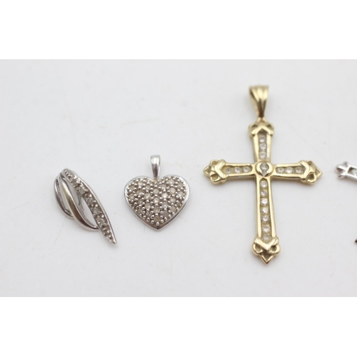 2005 - Four 9ct yellow and white gold diamond and topaz set pendants to include cross, heart etc. - approx.... 