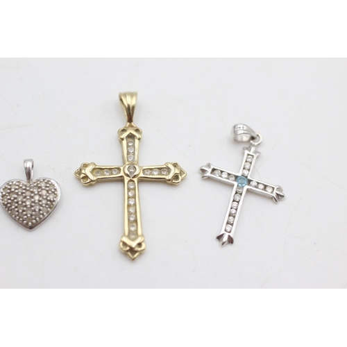 2005 - Four 9ct yellow and white gold diamond and topaz set pendants to include cross, heart etc. - approx.... 