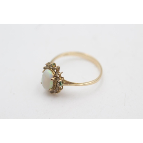 2017 - A 10ct gold white opal and clear gemstone halo dress ring, size P - approx. gross weight 1.9 grams