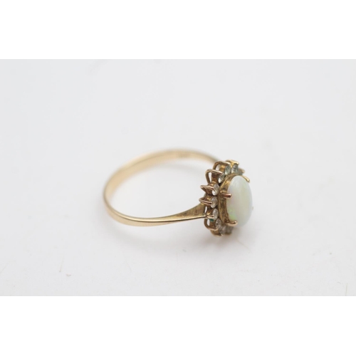 2017 - A 10ct gold white opal and clear gemstone halo dress ring, size P - approx. gross weight 1.9 grams