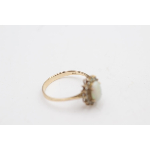 2017 - A 10ct gold white opal and clear gemstone halo dress ring, size P - approx. gross weight 1.9 grams