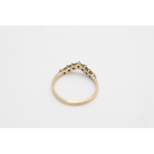 2023 - A hallmarked Birmingham 9ct gold sapphire and clear gemstone wishbone ring, size J - approx. gross w... 