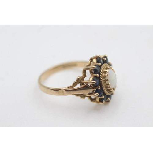 2034 - A hallmarked London 9ct gold opal and sapphire halo setting dress ring, size O½ - approx. gross weig... 