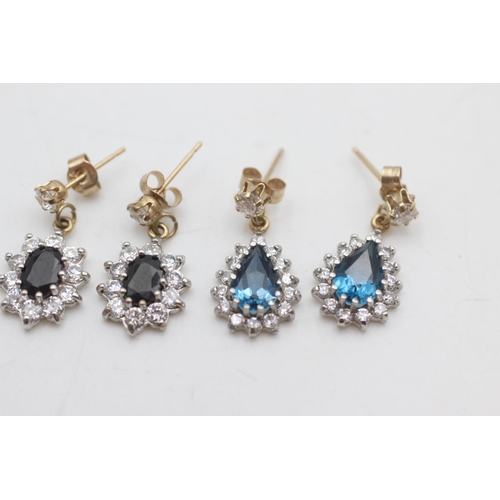 2038 - Two pairs of 9ct gold and clear gemstone halo drop earrings, one sapphire and one topaz - approx. gr... 