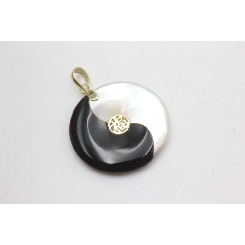 2044 - Two 14ct gold onyx, jade and mother of pearl ying and yang pendants - approx. gross weight 8.3 grams