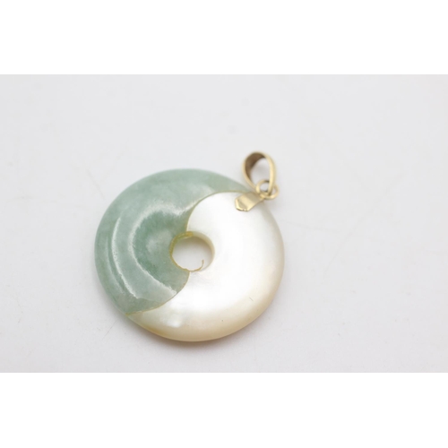 2044 - Two 14ct gold onyx, jade and mother of pearl ying and yang pendants - approx. gross weight 8.3 grams