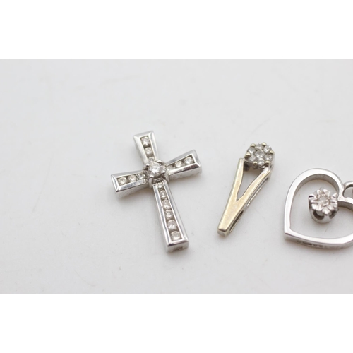 2051 - Three 9ct white gold diamond set pendants, one cross, one heart and one teardrop - approx. gross wei... 