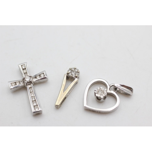 2051 - Three 9ct white gold diamond set pendants, one cross, one heart and one teardrop - approx. gross wei... 