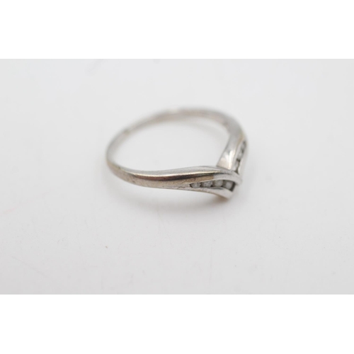 2055 - A 9ct white gold diamond channel setting wishbone ring, size K - approx. gross weight 1.7 grams