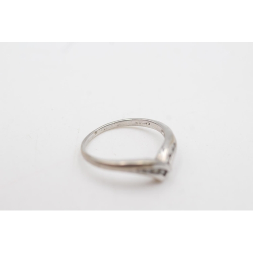 2055 - A 9ct white gold diamond channel setting wishbone ring, size K - approx. gross weight 1.7 grams