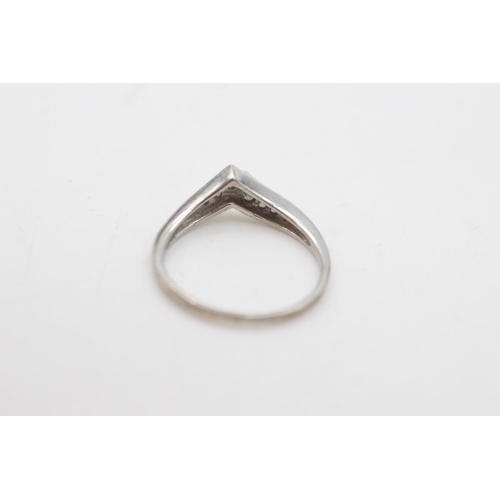 2055 - A 9ct white gold diamond channel setting wishbone ring, size K - approx. gross weight 1.7 grams