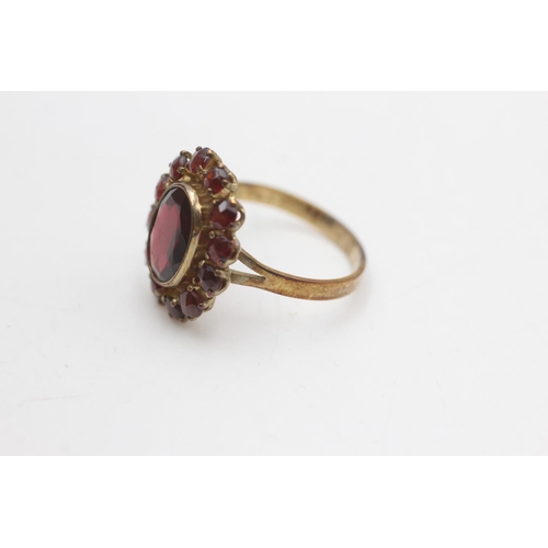 2101 - An 8ct gold garnet halo ring ,size O - approx. gross weight 3 grams