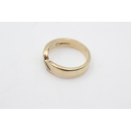 2107 - A hallmarked Birmingham 9ct gold diamond set single row wishbone ring, size J½ - approx. gross weigh... 