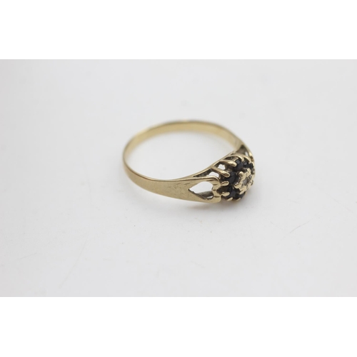 2111 - A 9ct gold diamond and sapphire floral set ring ,size P - approx. gross weight 1.5 grams