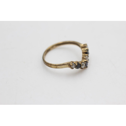 2114 - A 9ct gold sapphire and clear gemstone wishbone ring, size I - approx. gross weight 1 gram