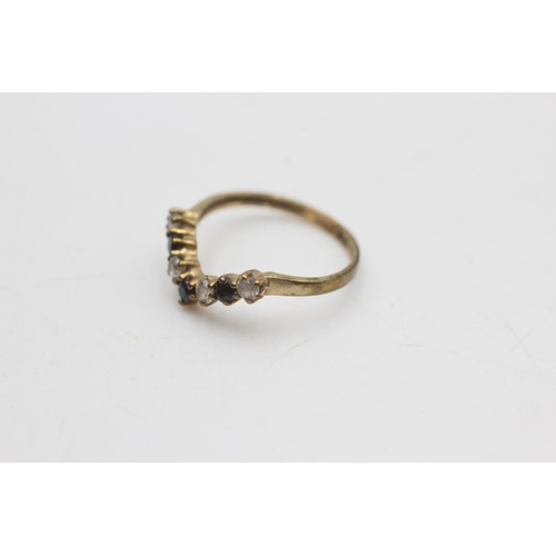 2114 - A 9ct gold sapphire and clear gemstone wishbone ring, size I - approx. gross weight 1 gram