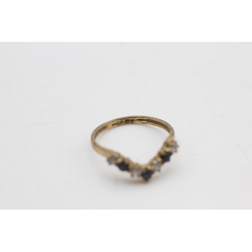 2114 - A 9ct gold sapphire and clear gemstone wishbone ring, size I - approx. gross weight 1 gram