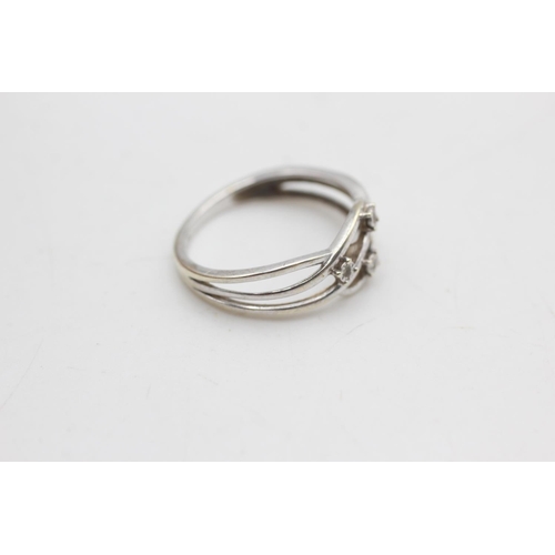 2134 - A 9ct white gold diamond twist knot band ring, size N½ - approx. gross weight 2 grams