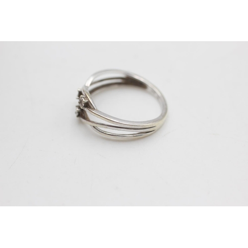 2134 - A 9ct white gold diamond twist knot band ring, size N½ - approx. gross weight 2 grams