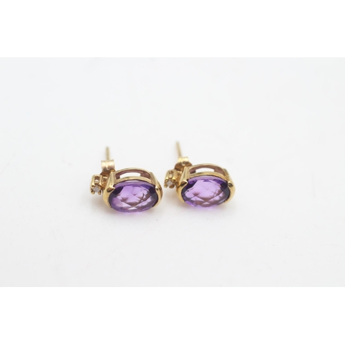 2141 - Two pairs of 9ct gold amethyst stud earrings, one pair with diamond - approx. .gross weight 2.4 gram... 