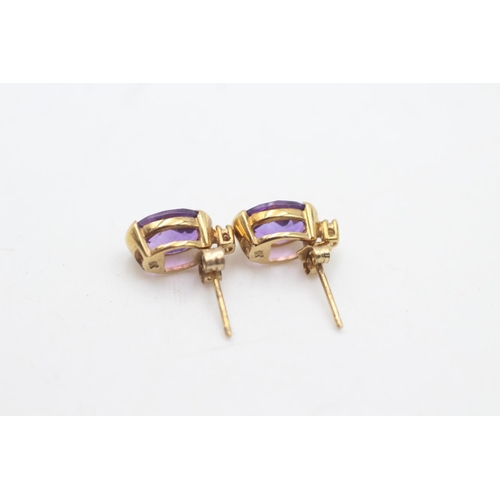 2141 - Two pairs of 9ct gold amethyst stud earrings, one pair with diamond - approx. .gross weight 2.4 gram... 