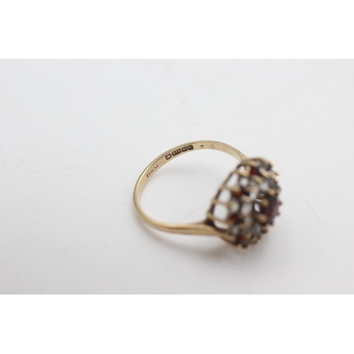 2143 - A hallmarked Birmingham 9ct gold garnet and synthetic spinel double halo dress ring, size P½ - appro... 