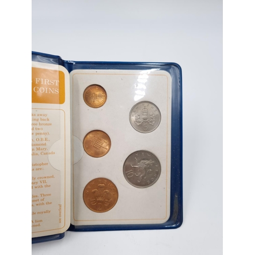 75 - A collection of assorted cased coins to include Coronation crowns, Britain's First decimal coin set ... 