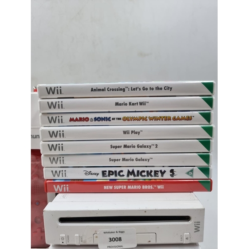 1528 - A large collection of Nintendo Wii consoles, games and accessories to include three consoles etc.