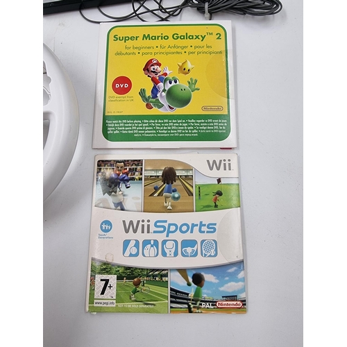 1528 - A large collection of Nintendo Wii consoles, games and accessories to include three consoles etc.