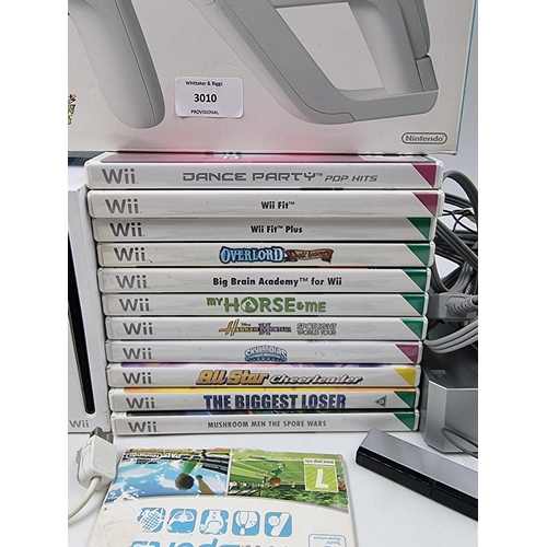 1526 - A large collection of Nintendo Wii consoles, games and accessories to include two consoles etc.