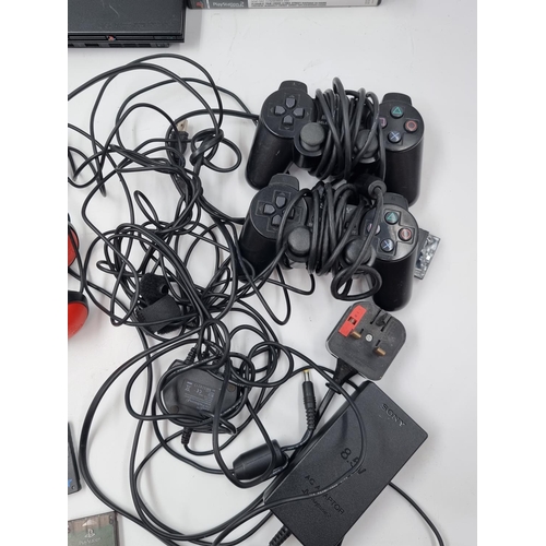 1520 - A PlayStation 2 slim console with BUZZ! accessories and games to include Gran Turismo 3 A-spec etc.