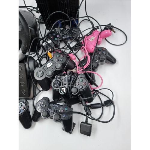 1517 - A large collection of PlayStation 2 accessories to include two consoles, various controllers and EV8... 