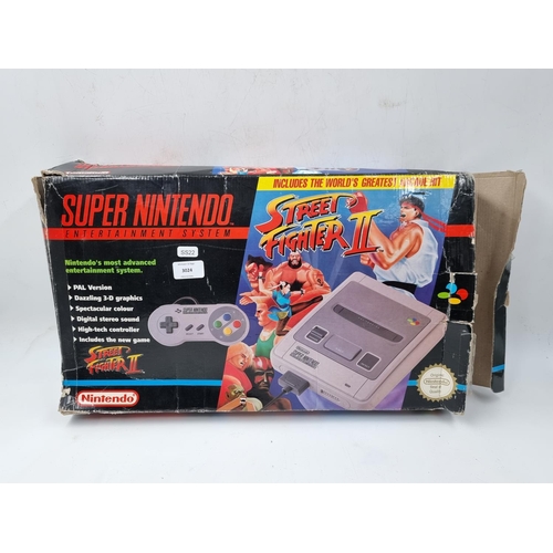 1513 - A boxed Super Nintendo entertainment system with Street Fighter 2 cartridge