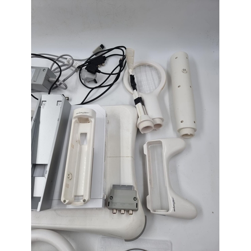 1511 - A collection of Nintendo Wii items to include Wii Fit board, accessories and games