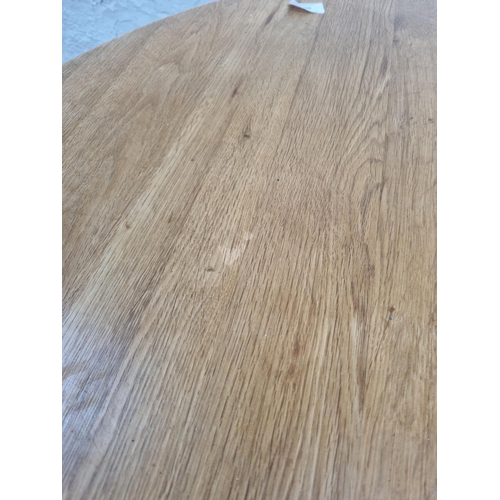 1007 - A modern solid oak circular dining table - approx. 77cm high x 109cm diameter